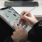 An image of a man drawing on an iPad using the Apple Pencil 2 or the second-generation Apple Pencil.