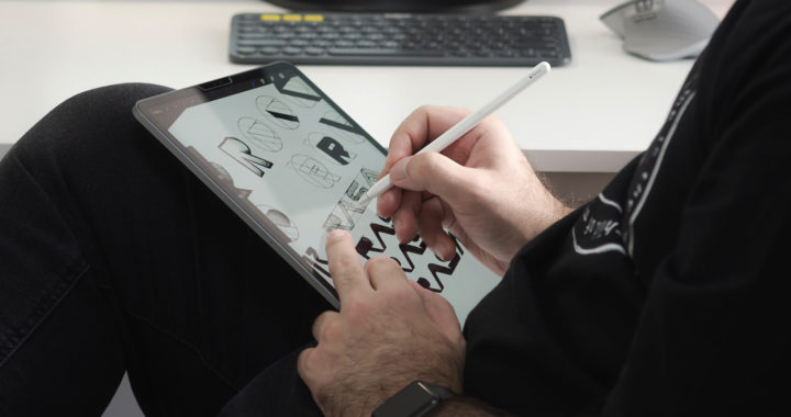 An image of a man drawing on an iPad using the Apple Pencil 2 or the second-generation Apple Pencil.