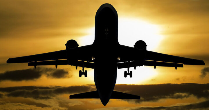 A silhouette of an airplane in front of a sunset for the article "Link Between Climate Change and Plane Turbulence Frequency"